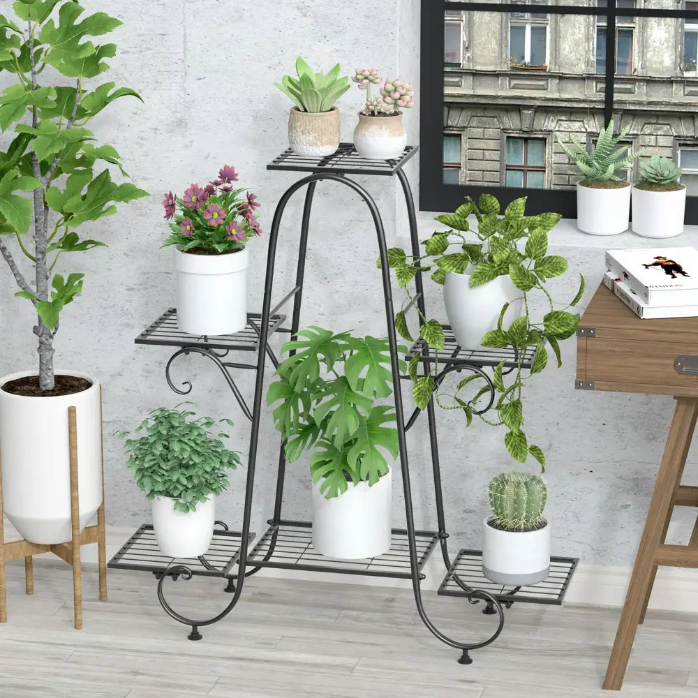 Black wrought iron metal plant stand with three tiers and decorative scrollwork for elegant plant display
