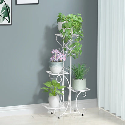 White wrought iron metal plant stand with ornate scrollwork and four tiered shelves for flower pots by DecorBites