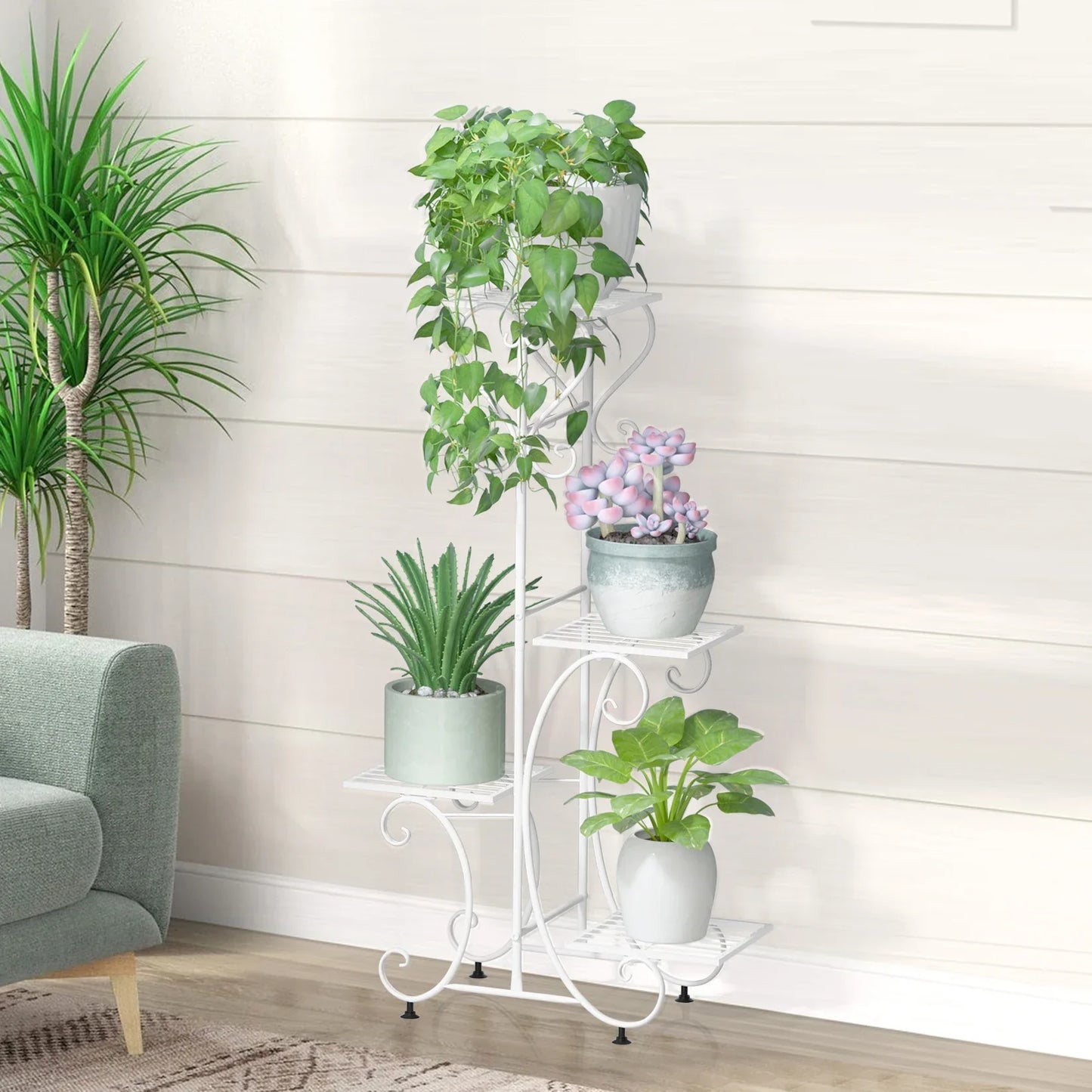 White wrought iron metal plant stand decorbites™ with ornate scrollwork and four tiers holding potted greenery