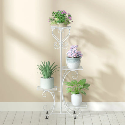 White wrought iron metal plant stand with ornate scrollwork and four tiered shelves for flower pots by decorbites
