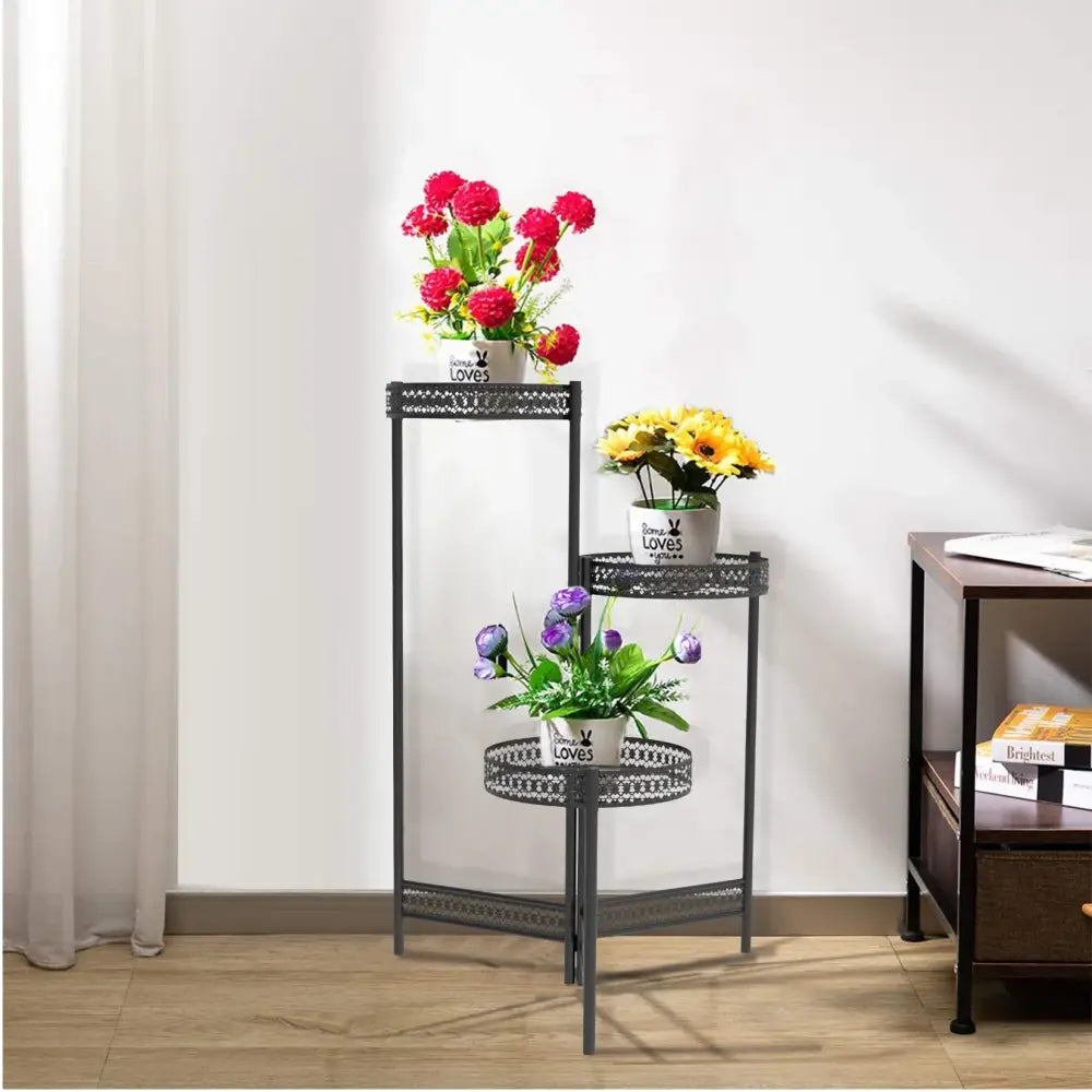 Black metal three-tiered decorbites metal plant stand with decorative lattice shelves for indoor and outdoor living room use