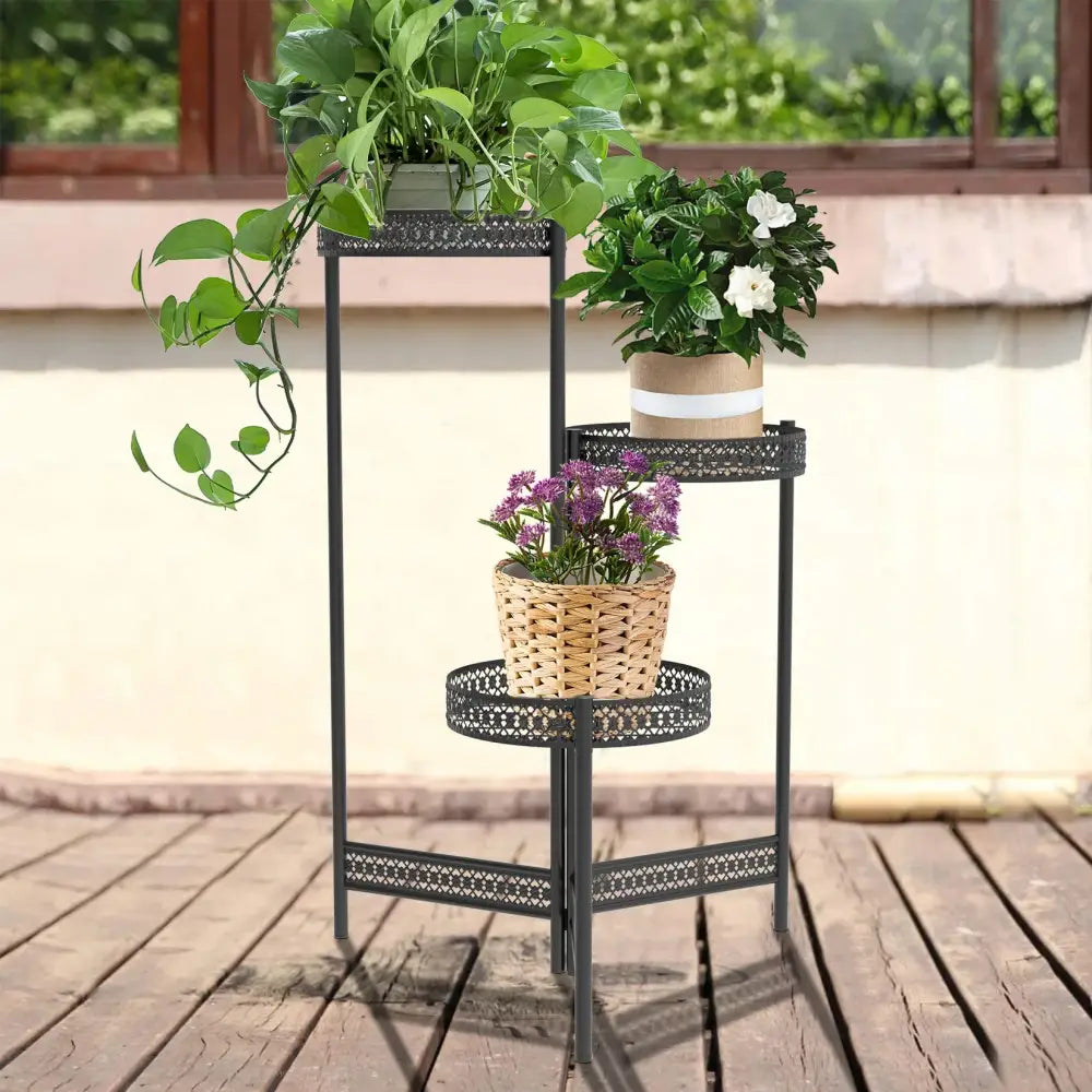 Black metal plant stand DecorBites with three ornate lattice tiers holding potted plants for indoor and outdoor use