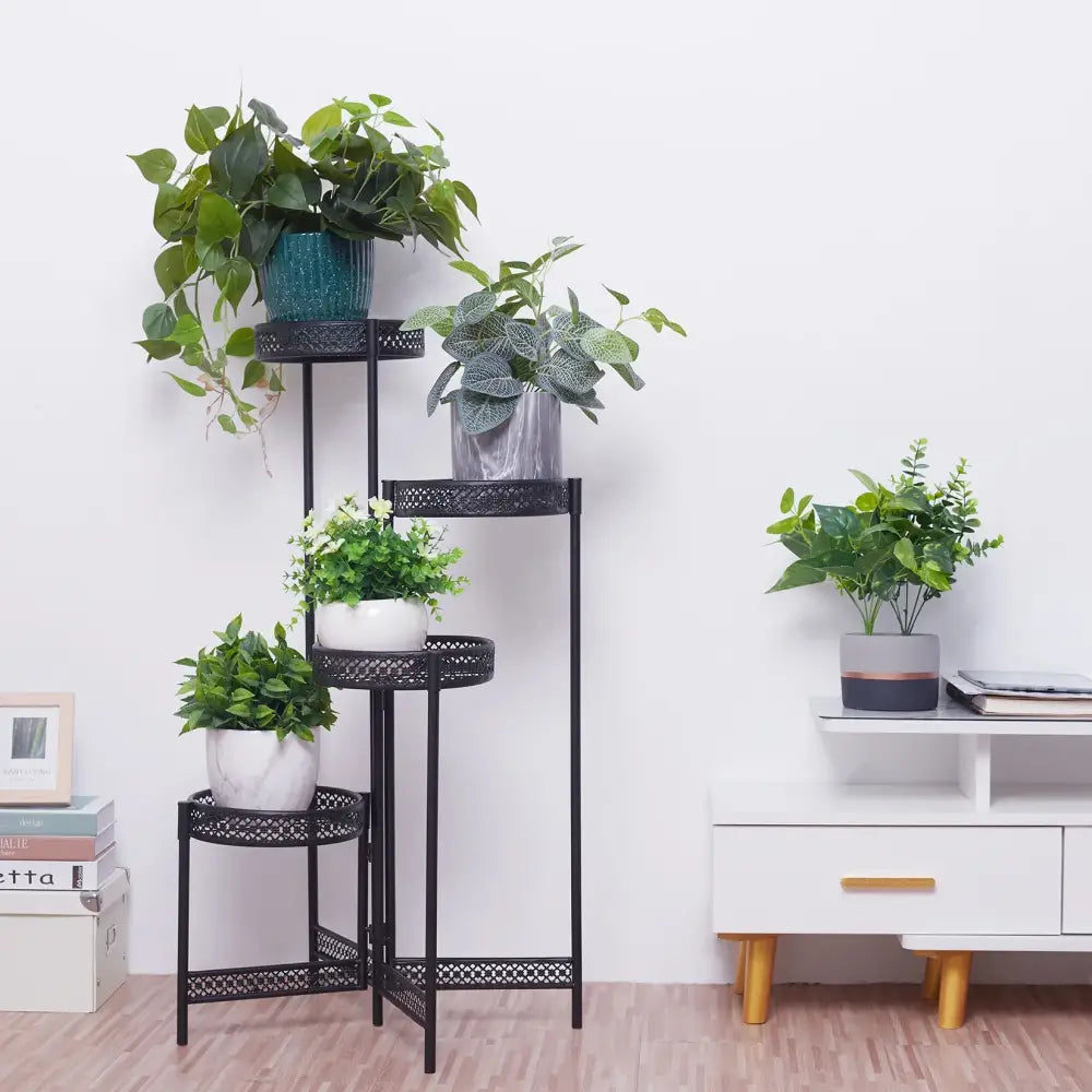 Black metal tiered plant stand with decorative lattice design for indoor and outdoor use in living room spaces