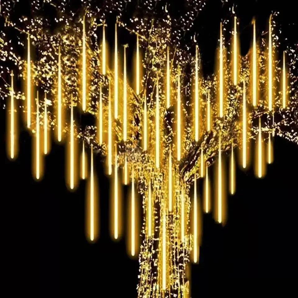 Decorbites meteor shower golden led string lights with elongated rainlight design hanging from a tree outdoors