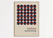 Beige DecorBites™ mid century geometric wall art featuring red and navy halved circles on canvas with light wood frame