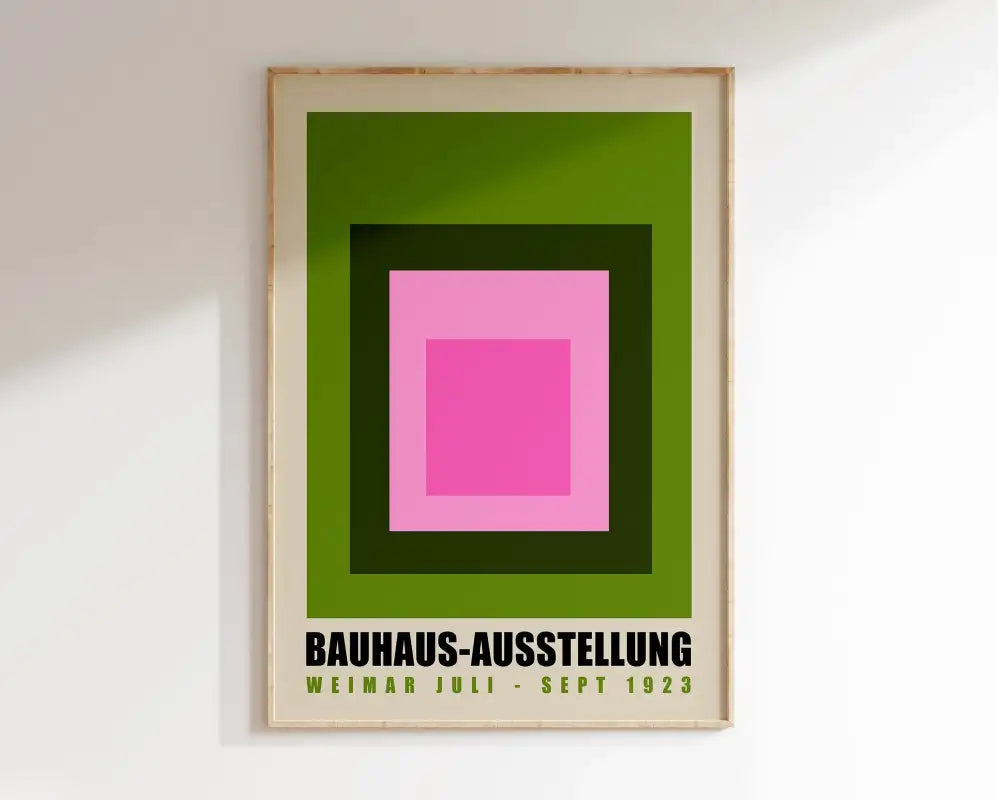 A framed DecorBites mid century geometric canvas wall art with pink and green concentric squares and black text