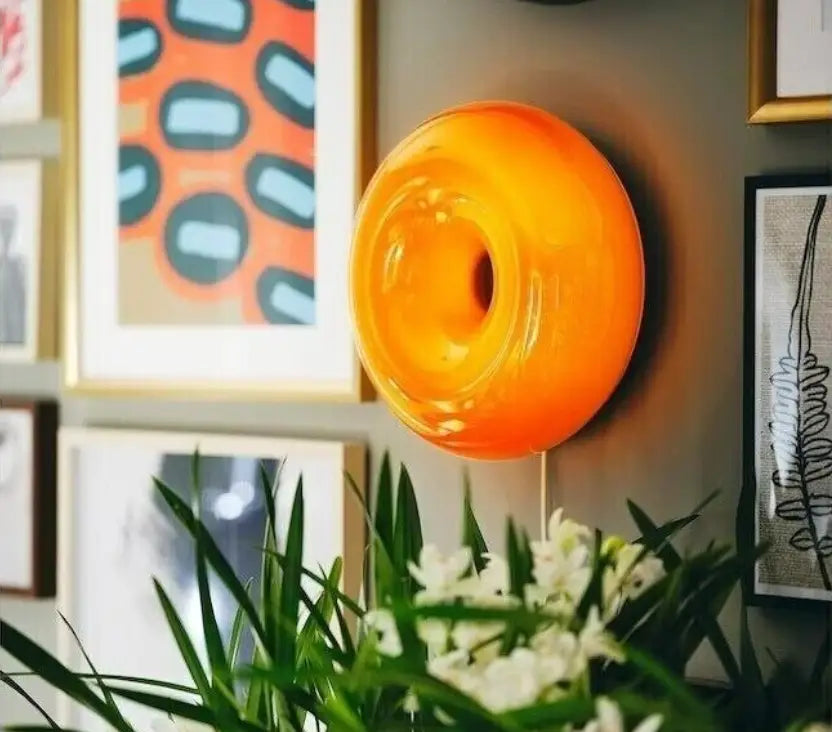 Vibrant orange translucent glass wall sconce with circular donut design for modern desk lamp decorbites bauhaus furniture