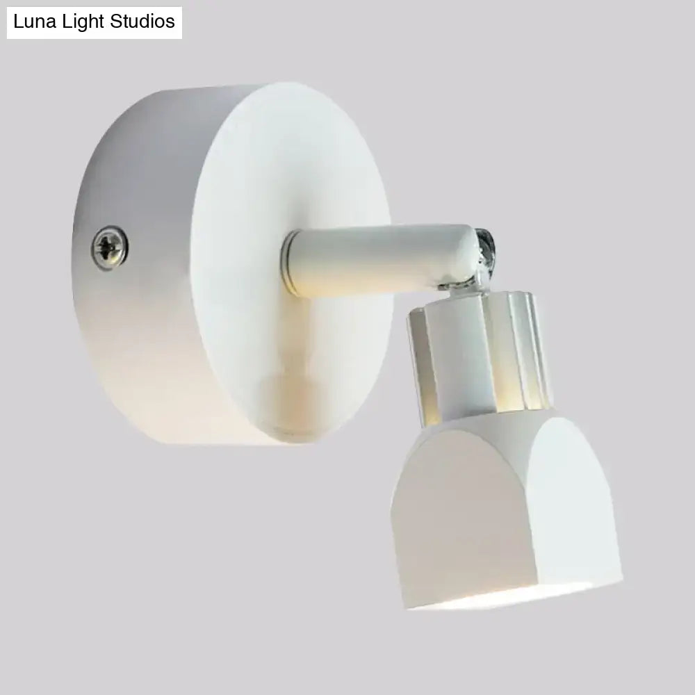 White wall lamp with a sleek circular base and adjustable arm in contemporary style direct wired electric design