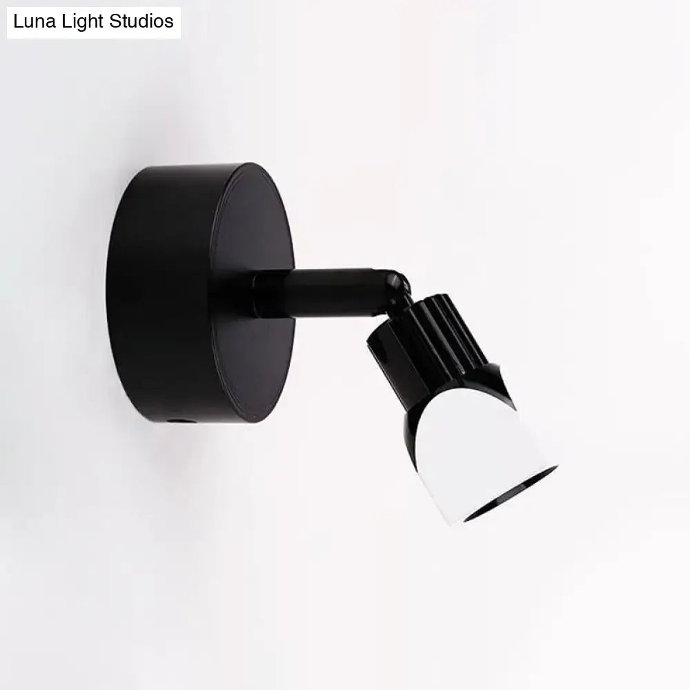Contemporary style direct wired electric black wall lamp with matte base and white diffuser lens for bedroom spotlight use