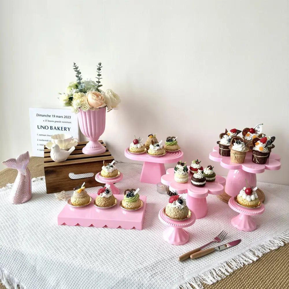 Pink ceramic cake stands with scalloped edges display miniature desserts with decorbites™ mini flower arrangement vase