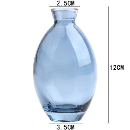 DecorBites™ mini glass flower vase made of translucent light blue glass with rounded body and narrow neck for home decor