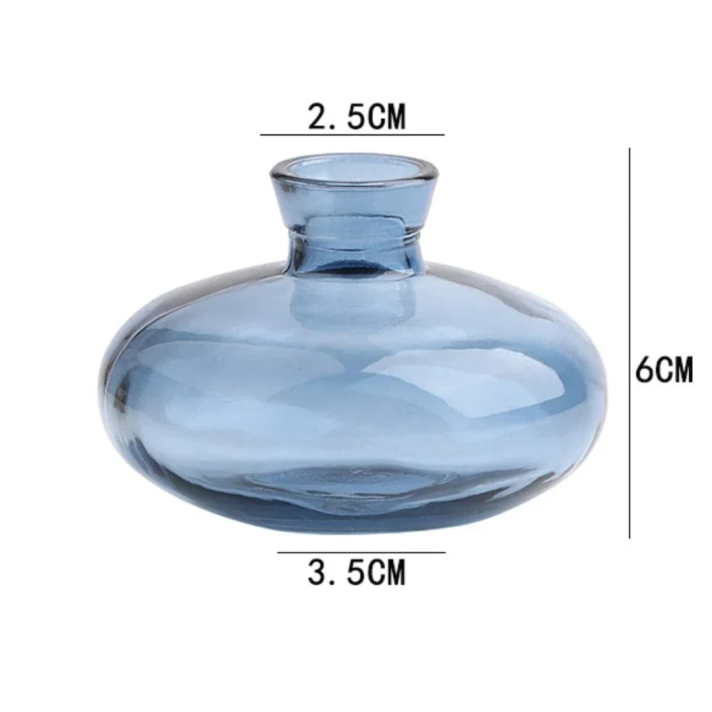 DecorBites™ mini glass flower vase in translucent blue with a rounded bulbous body and short neck for home decor