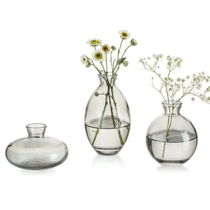 Set of three clear glass DecorBites™ mini flower vases with rounded minimalist design for home decor