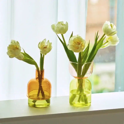DecorBites™ mini glass vase set features amber and lime green translucent glass vases holding white tulips
