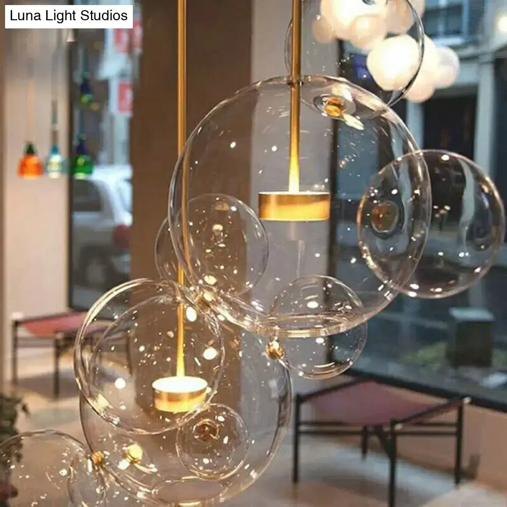 Decorbites™ minimal brass bubble pendant light with 5 clear glass heads featuring modern design and warm led lights