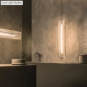 DecorBites minimalist hanging lamp with clear acrylic shade and acrylic pipe features a sleek translucent body and warm glow