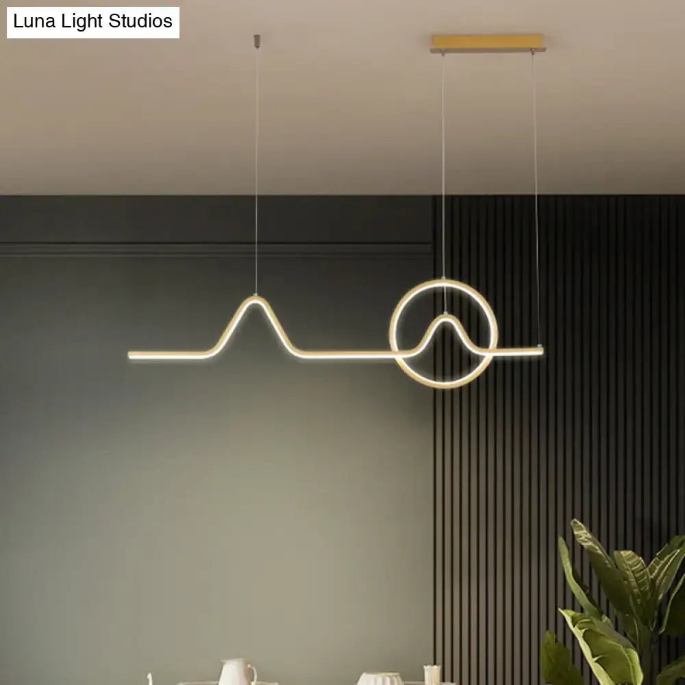 Modern gold-toned minimalist aluminum led dining room pendant light with mountain and sun design by DecorBites™