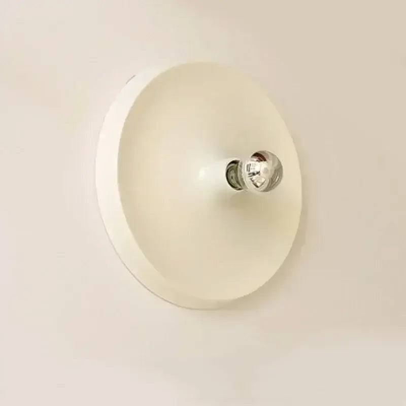 Off-white circular wall-mounted bauhaus lamp with central chrome bulb holder by decorbites minimalistic design