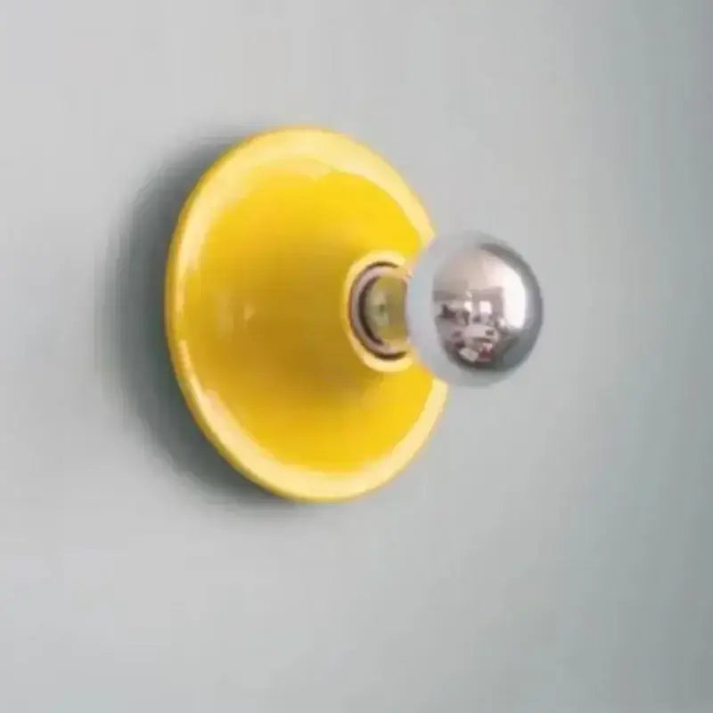 Vibrant yellow ceramic decorbites bauhaus lamp with polished chrome spherical bulb wall-mounted light fixture