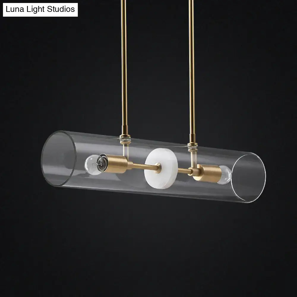 Modern cylindrical glass pendant light with brass accents and white marble disc suspended lighting fixture with clear glass tubes