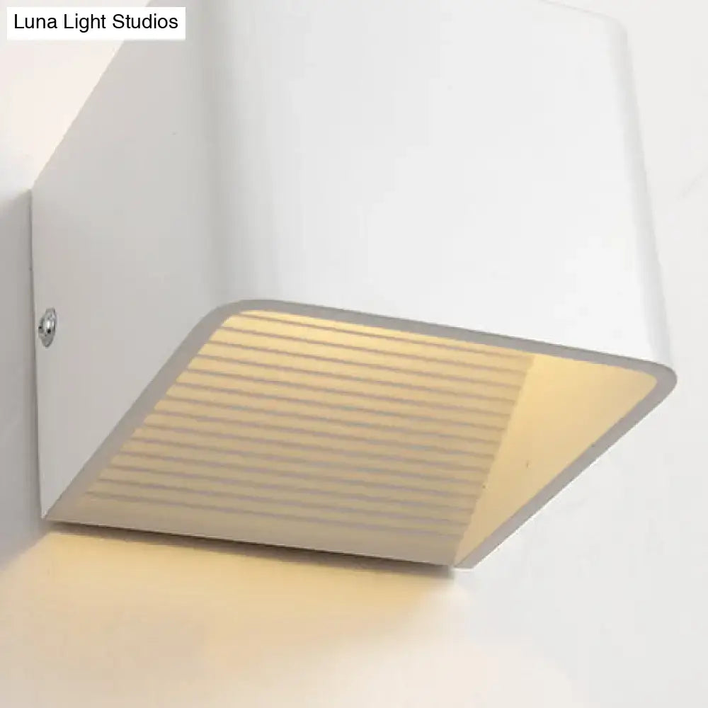 Modern white wall-mounted sconce light with a ribbed minimalist cube shade and warm diffused glow for living room decorbites minimalist cube