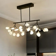 Modern black metal ceiling light with frosted glass globe bulbs and branching design for dining room fixture width