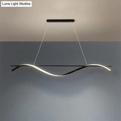 Modern black DecorBites™ minimalist LED hanging island light with curved strip emitting warm white illumination