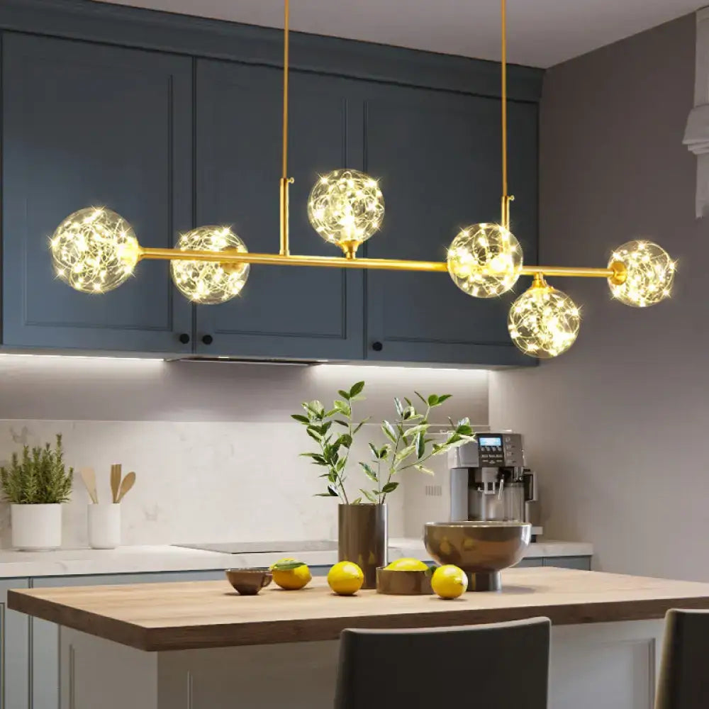 DecorBites minimalist LED pendant ceiling light with brass finish and clear glass sphere shade featuring five glowing globes