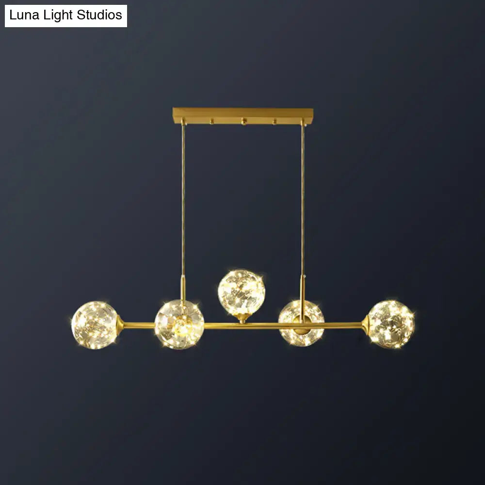 DecorBites™ minimalist ceiling light with gold-toned brass finish and clear glass sphere shade featuring five crystal bulbs