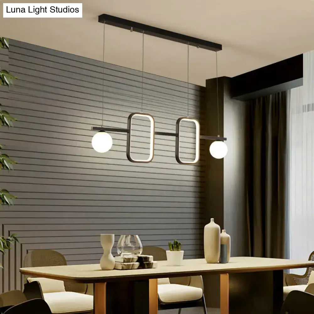 Modern black metal pendant light with symmetrical geometric led design and cream glass shade for dining room island