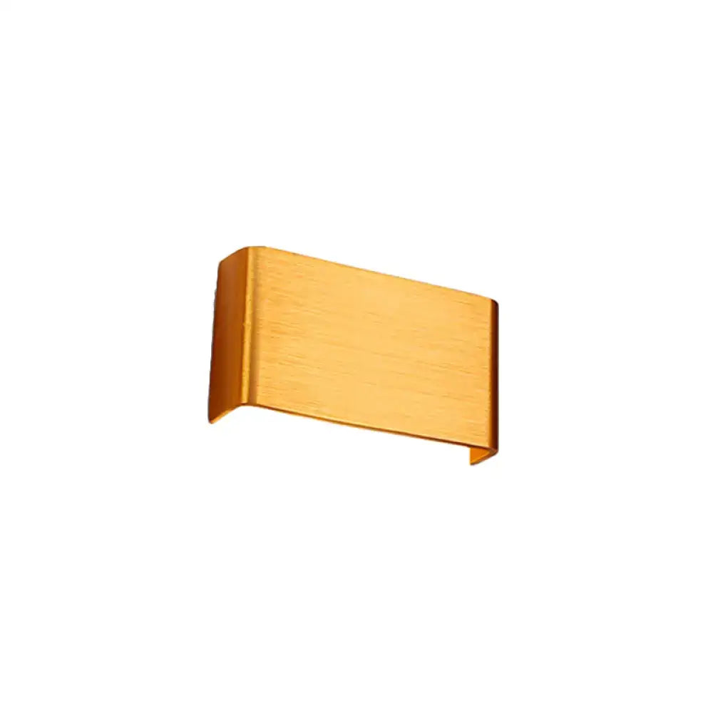 Gold-colored brushed metal money clip with sleek rectangular design complementing minimalist black silver wall lamp for living room warm white light