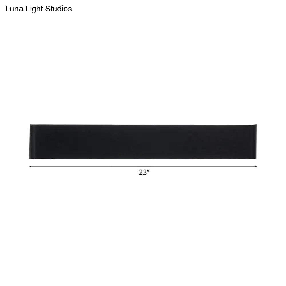 Black rectangular wall-mounted shelf 23 inches long complementing minimalist black and silver led wall lamp for living room warm white light
