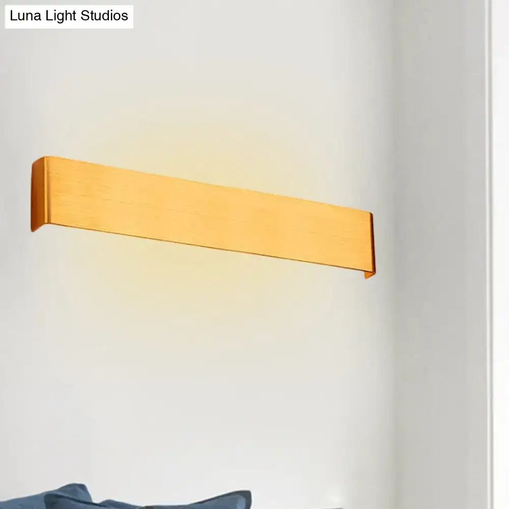 Gold-finished rectangular wall lamp with sleek modern design providing warm white light for living room use