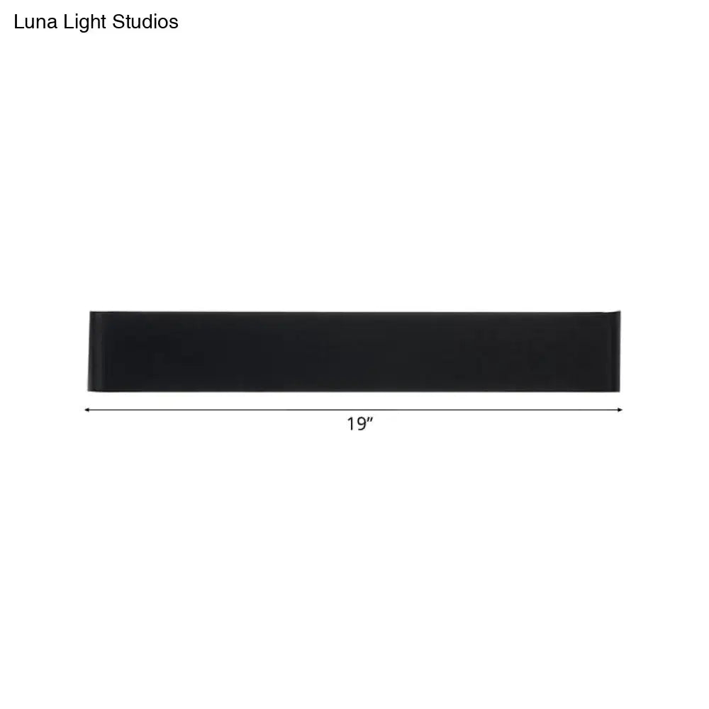 Black rectangular table runner 19 inches long displayed with minimalist black and silver wall lamp for living room warm white light