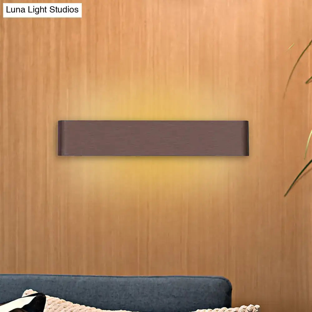 A sleek rectangular dark bronze wall lamp with warm white led light for living room illumination