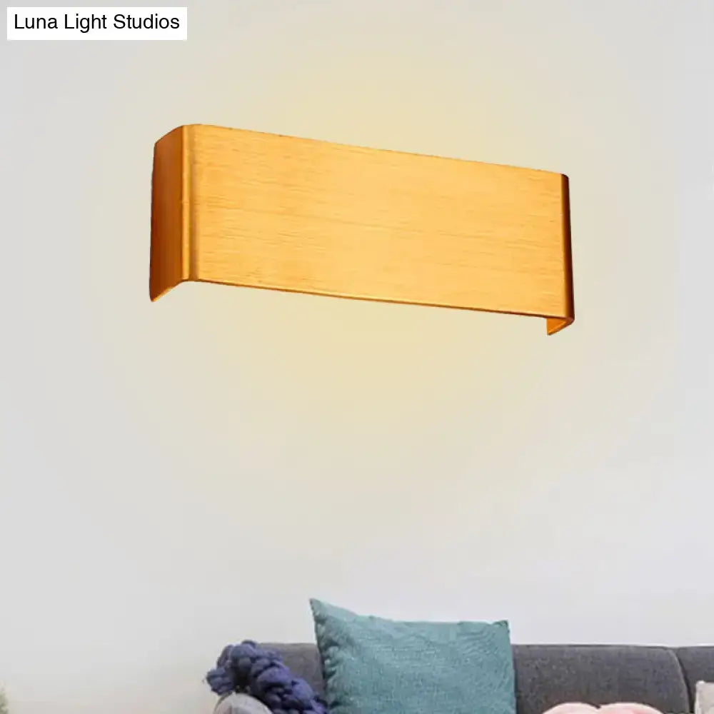 Gold-finished rectangular wall lamp with modern design providing warm white light for living room use