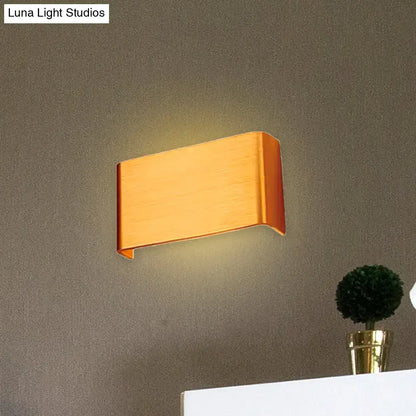 Modern copper-finished wall lamp with sleek angular design providing warm white light for living room use