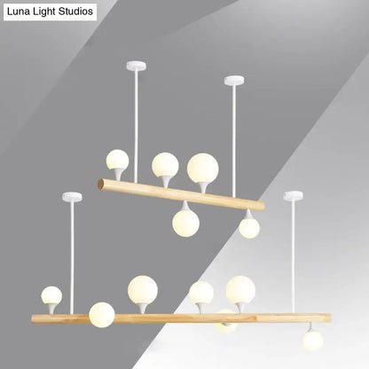 Modern two-tier decorbites™ linear hanging island pendant light with natural wood bars and white opal glass globes for restaurants