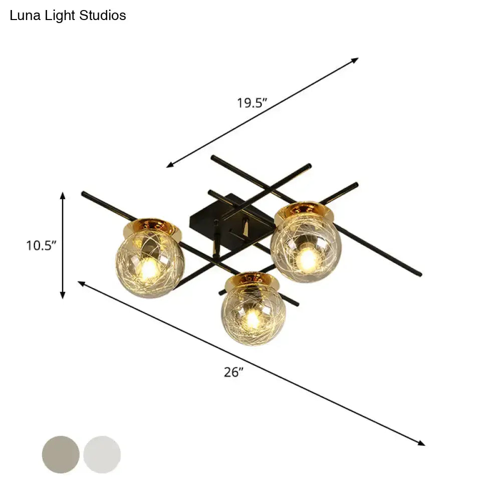 Modern black metal ceiling fixture with three clear smoke gray textured glass globes and gold-toned accents for bedroom use