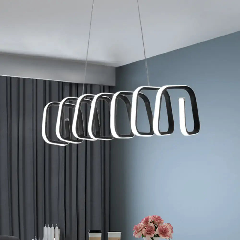 Modern black and white metal LED island light with a sleek geometric design for dining room ceilings by DecorBites