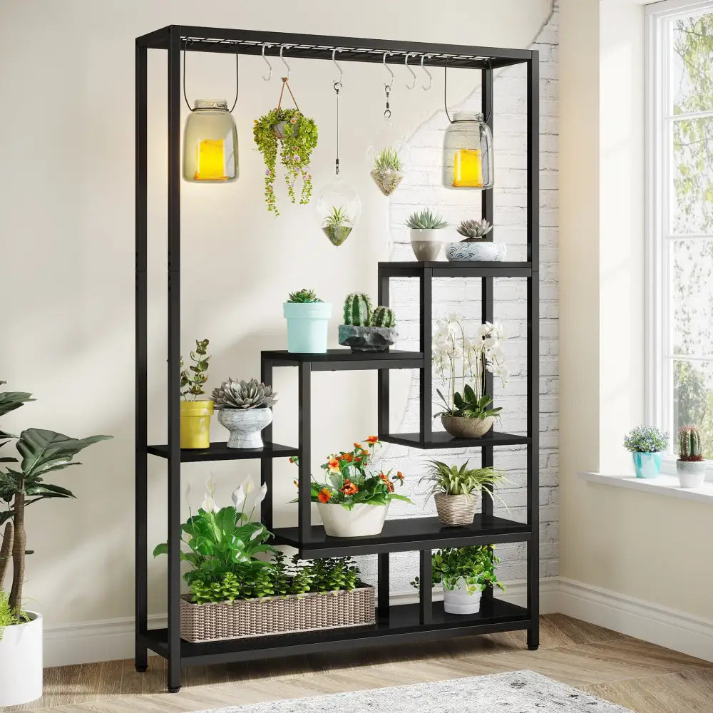 DecorBites™ modern black metal plant stand with five shelves and hooks displaying assorted potted plants and jars