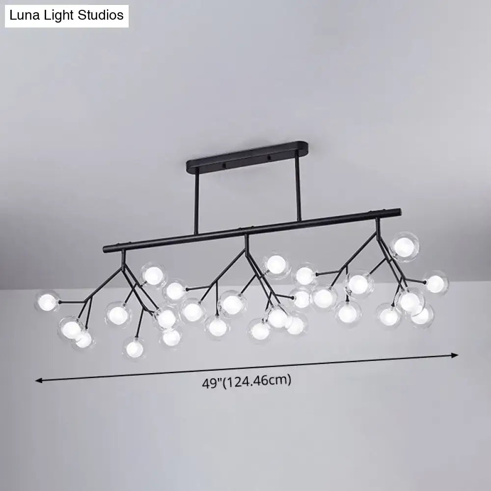 Black metal DecorBites™ firefly island pendant with 27 clear glass globe bulbs in a branching island pendant design