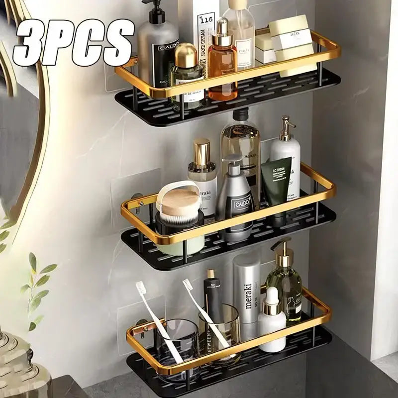 Set of three black and gold aluminum bathroom corner caddy shelves with perforated space aluminum surfaces