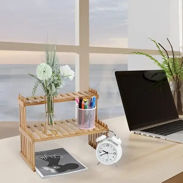 DecorBites™ modern bamboo 2-tier plant display stand with slatted shelves holding white flowers and a pink container