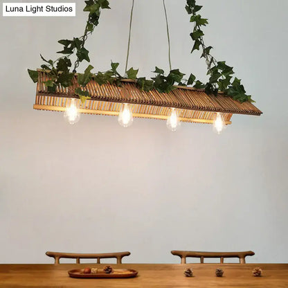 Rattan rectangular pendant light with hanging green ivy and four exposed bulbs in a decorbites triangle roof fixture