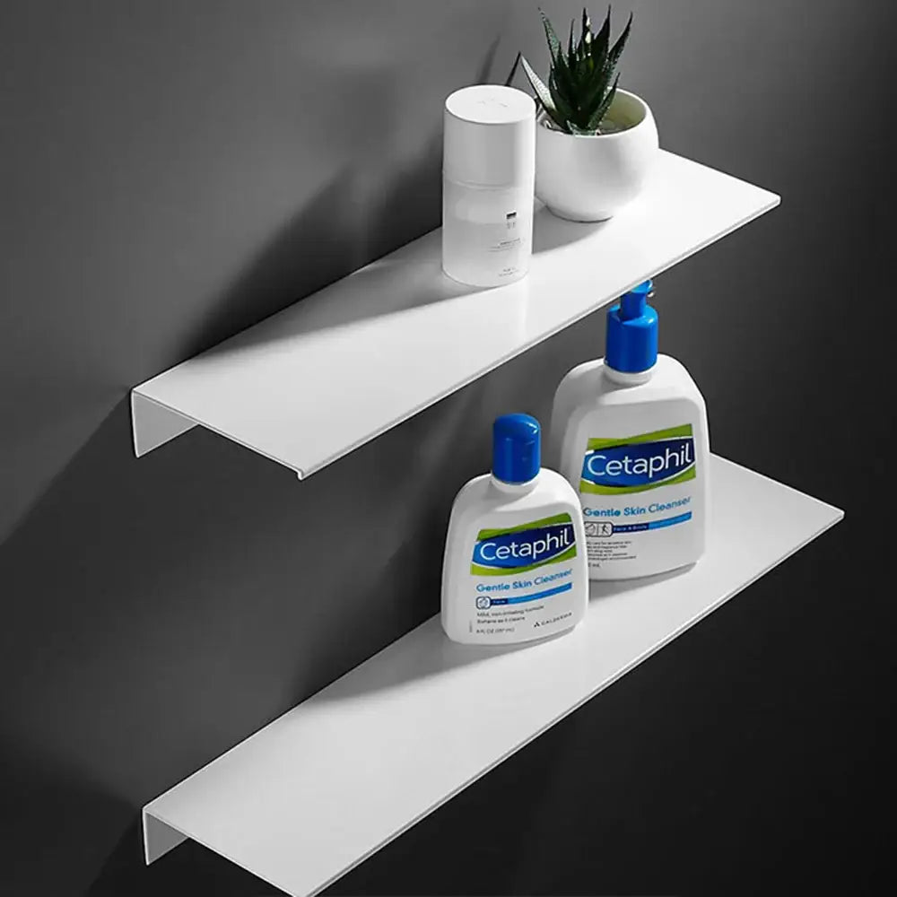 Decorbites modern black and white wall-mounted organizer shelf with white aluminum alloy holding cetaphil products and plant