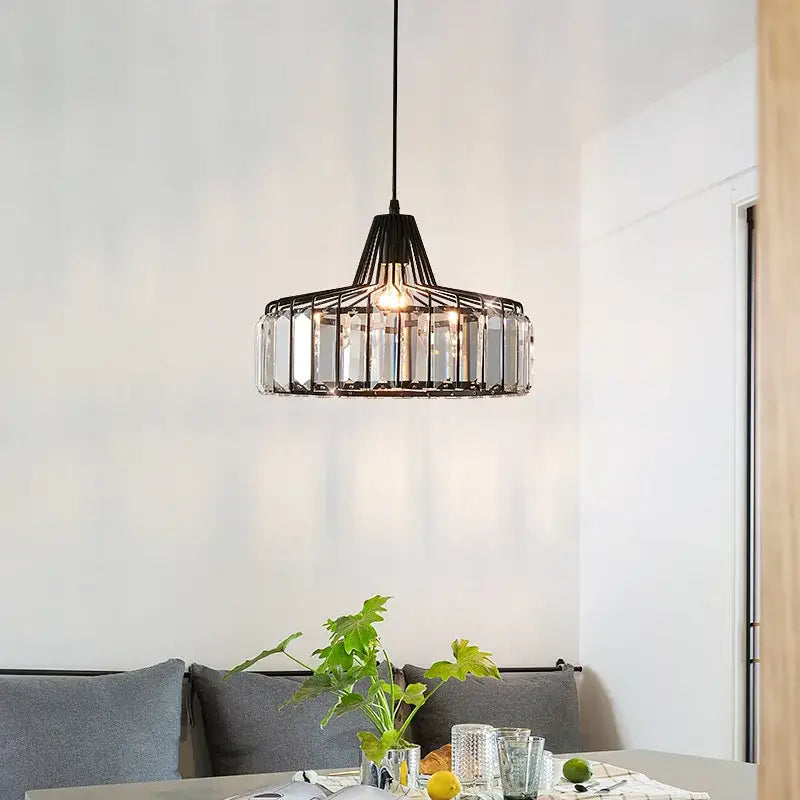 DecorBites™ modern black crystal led pendant lamp with clear crystal glass accents hanging above dining table
