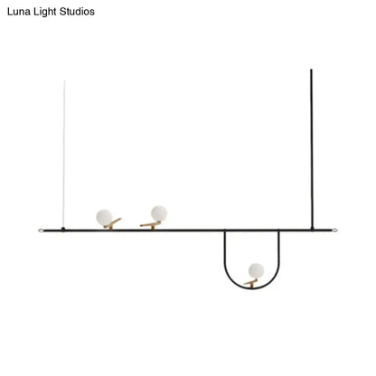 Minimalist black metal light fixture with three white glass sphere shades and cream accents for glass sphere island lighting