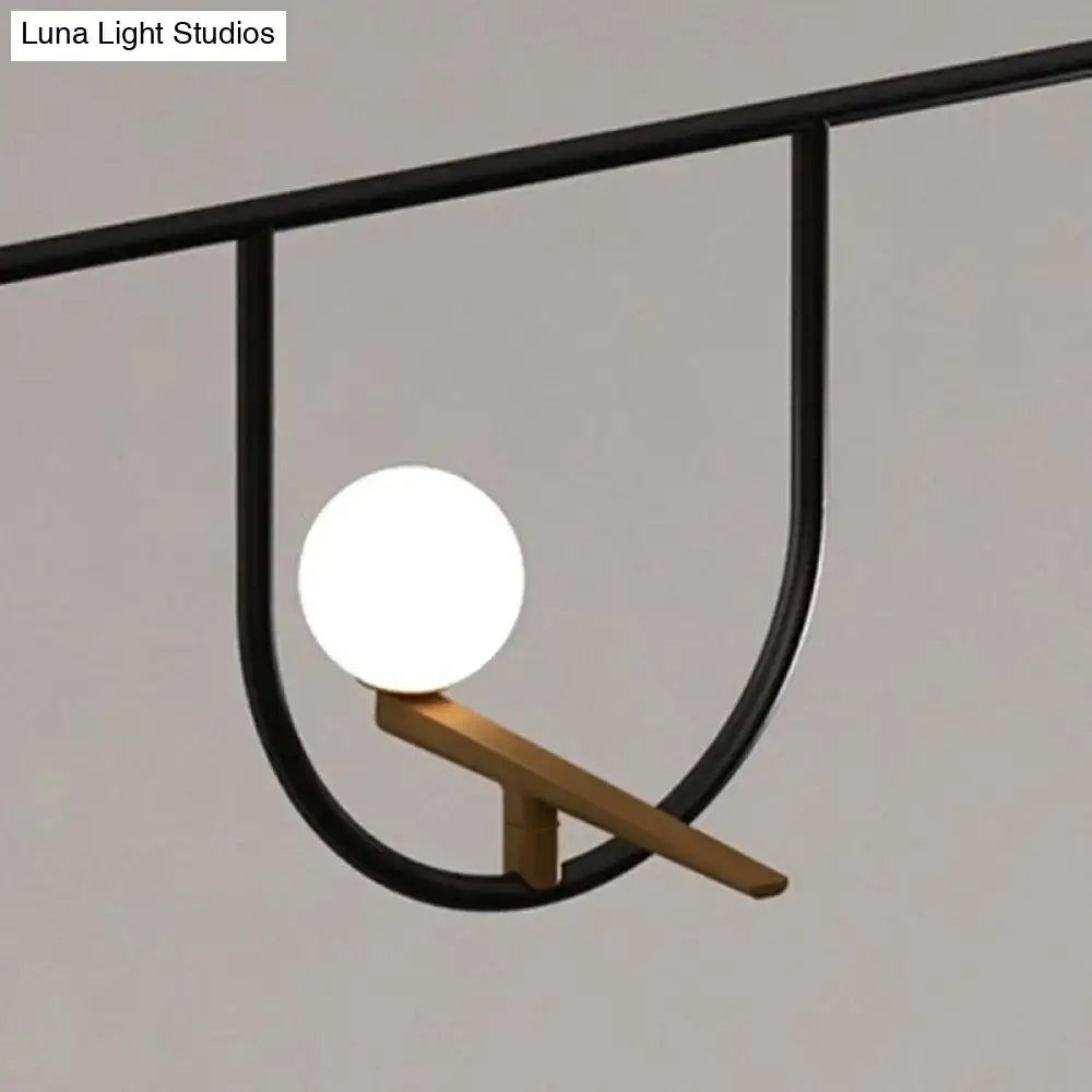 DecorBites modern black glass sphere island light fixture with sleek metal frame and cream accents for ceiling mounting