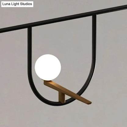 DecorBites modern black glass sphere island light fixture with sleek metal frame and cream accents for ceiling mounting